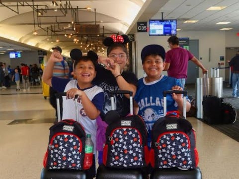 Kids posing with suitcases