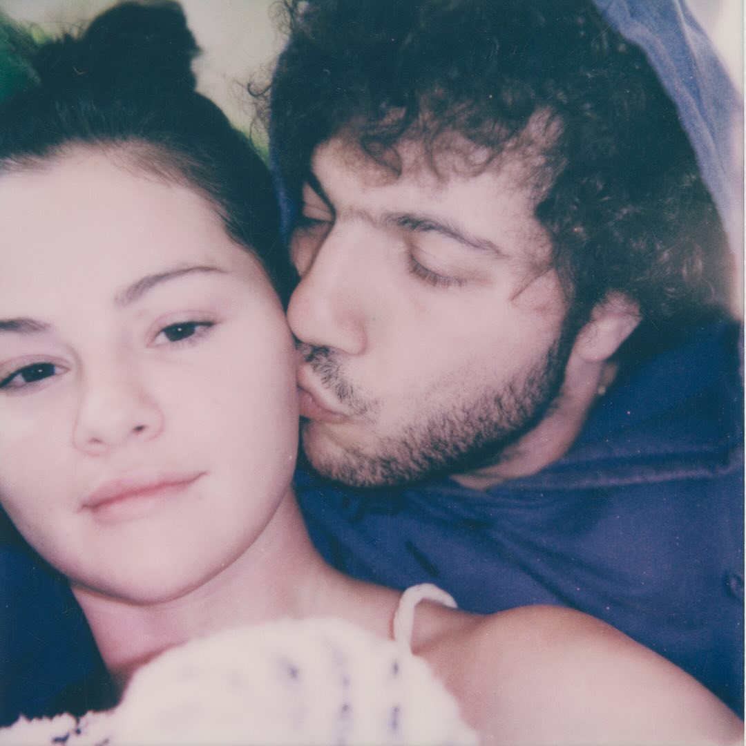 Selena Gomez being kissed on the cheek by Benny Blanco. 