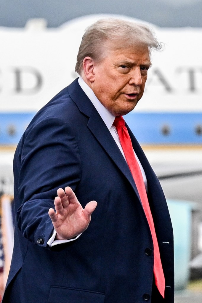Donald Trump gesturing during a meeting with Vladimir Putin in Anchorage.