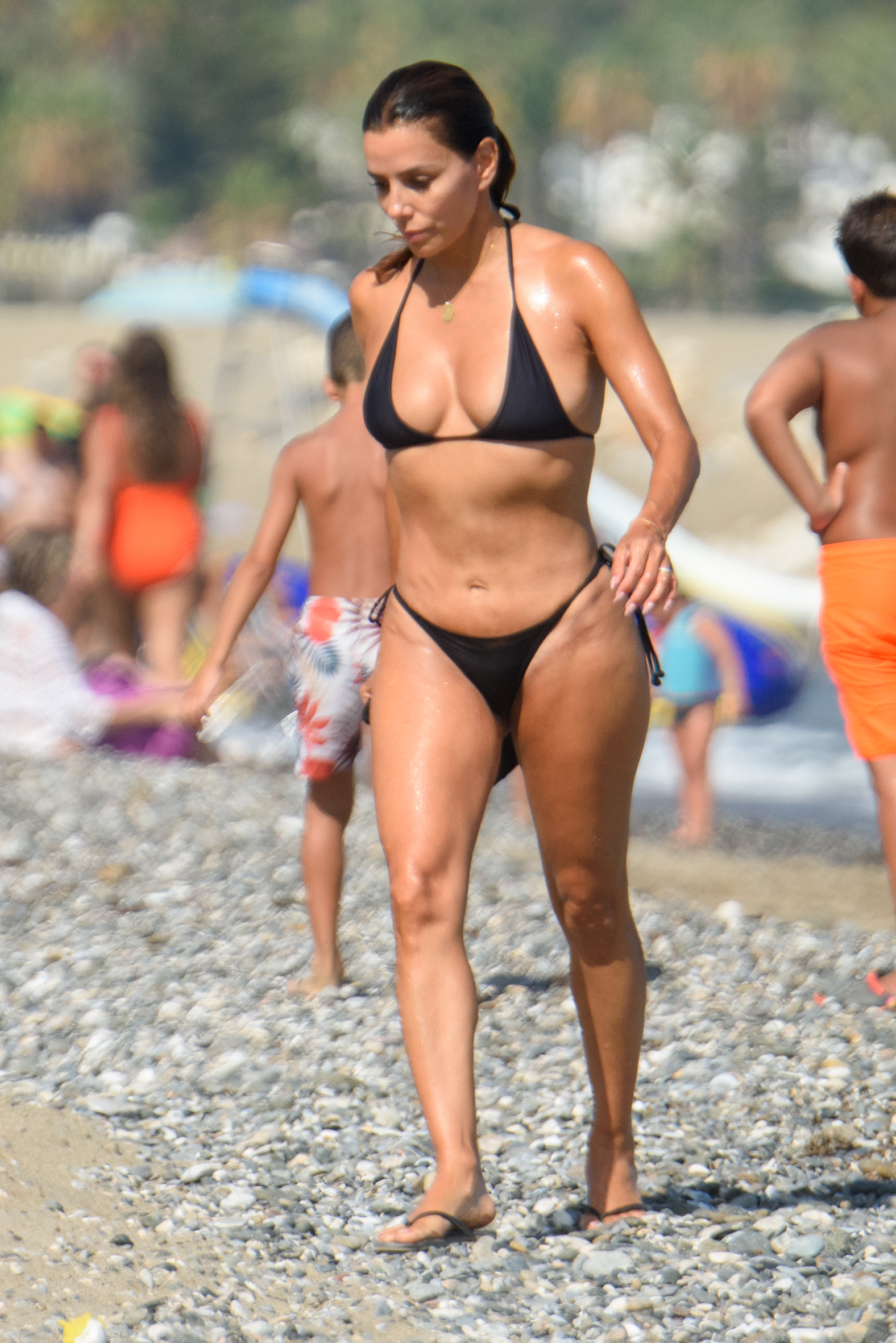 Eva Longoria in a black string bikini on the beach. 
