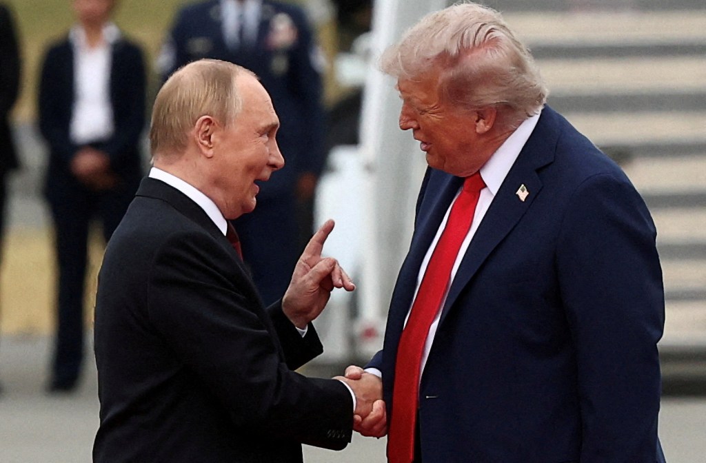 President Trump and President Putin shaking hands.