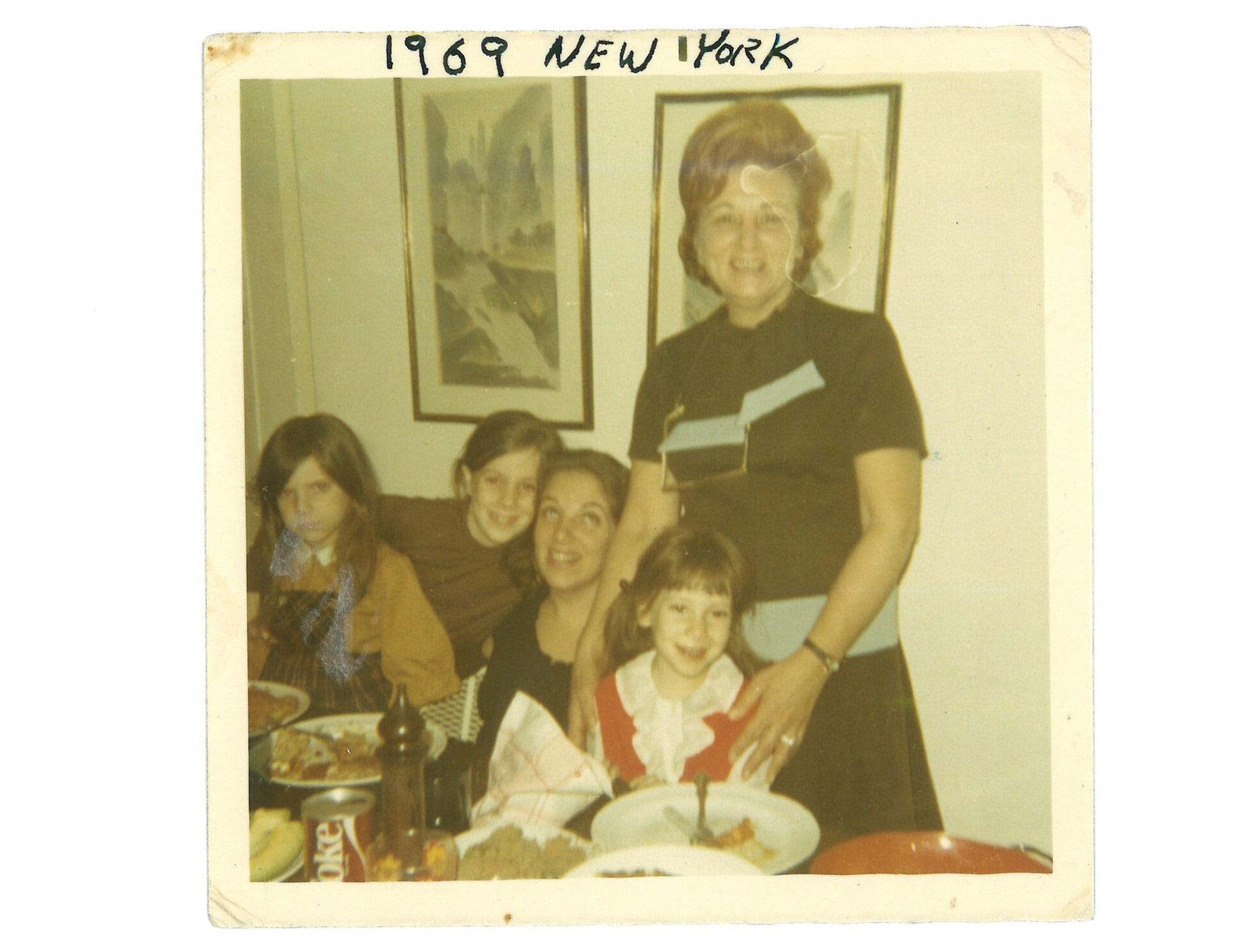 The author (as a child) poses with her grandmother and other family members.