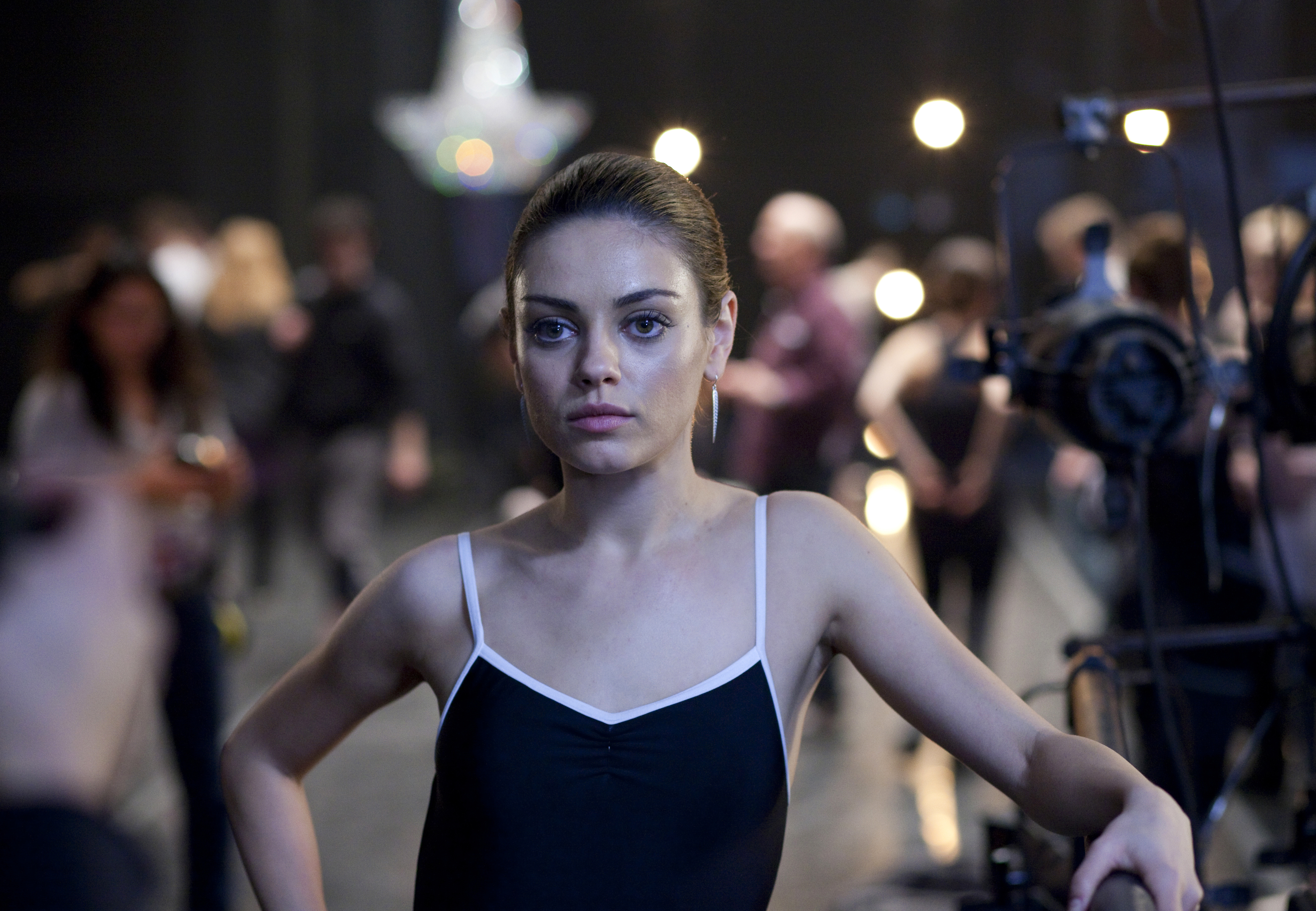 Mila Kunis in a black leotard. 