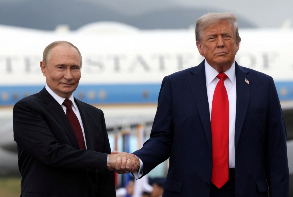 Presidents Vladimir Putin and Donald Trump shaking hands at Alaska summit on Aug. 15, 2025