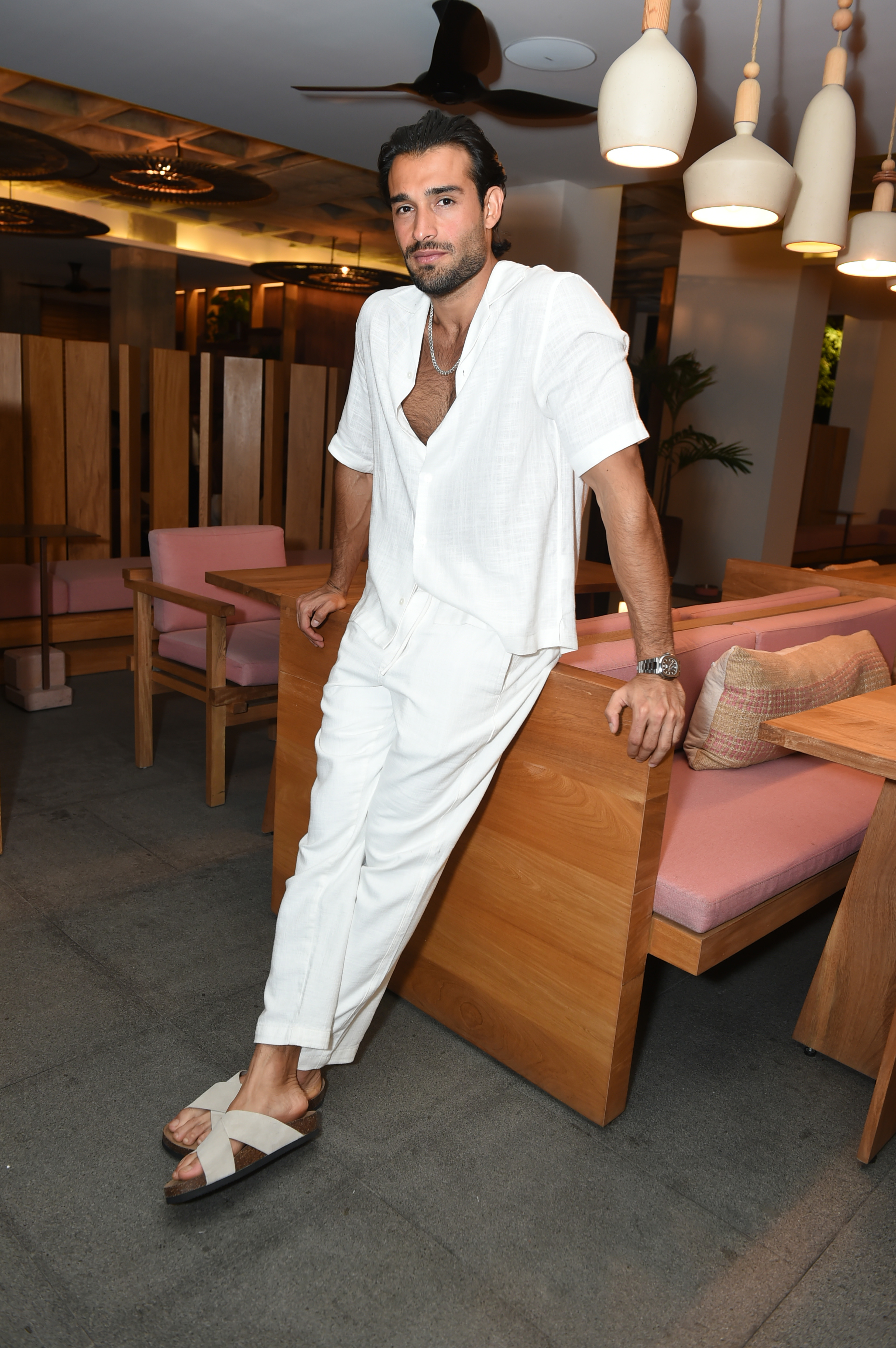 Sam Asghari in a white outfit. 