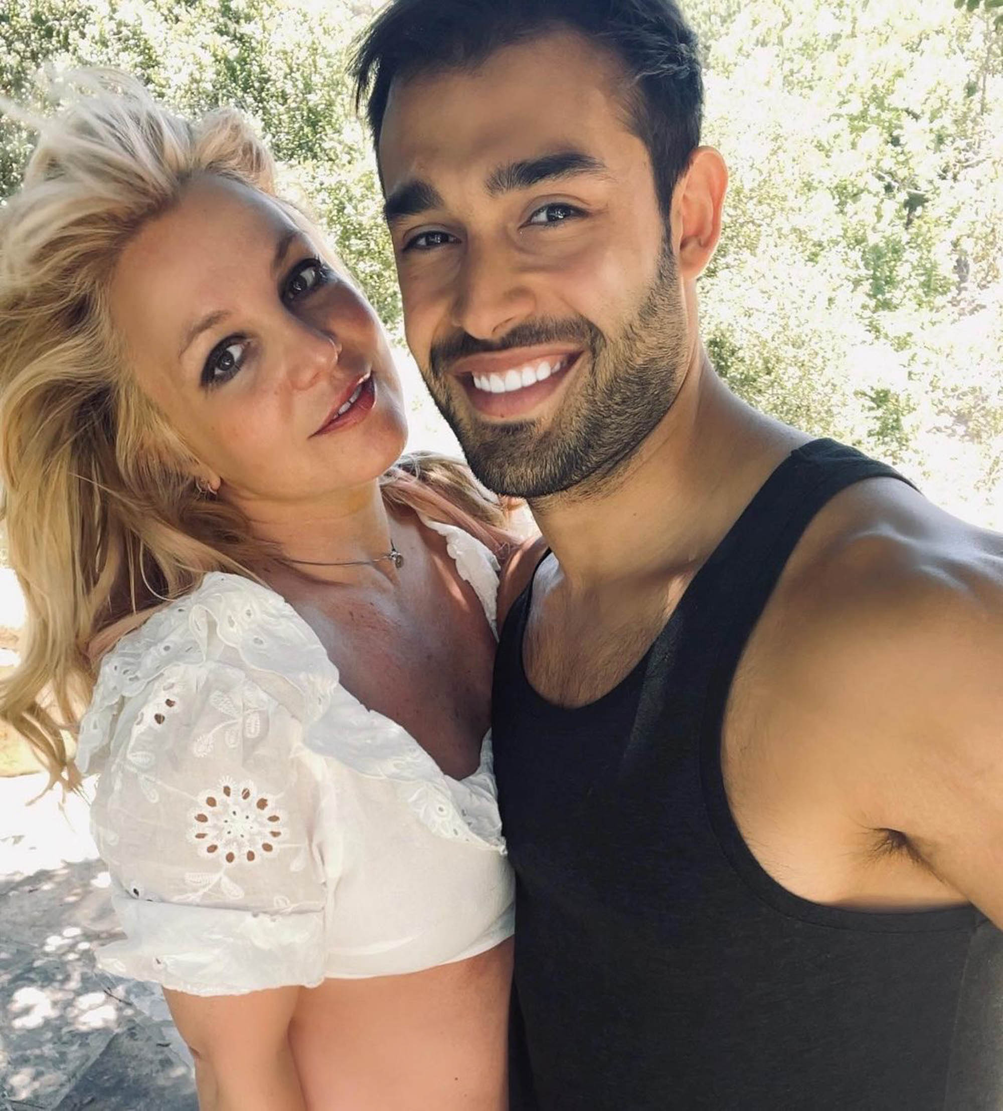 Britney Spears and Sam Asghari smiling. 