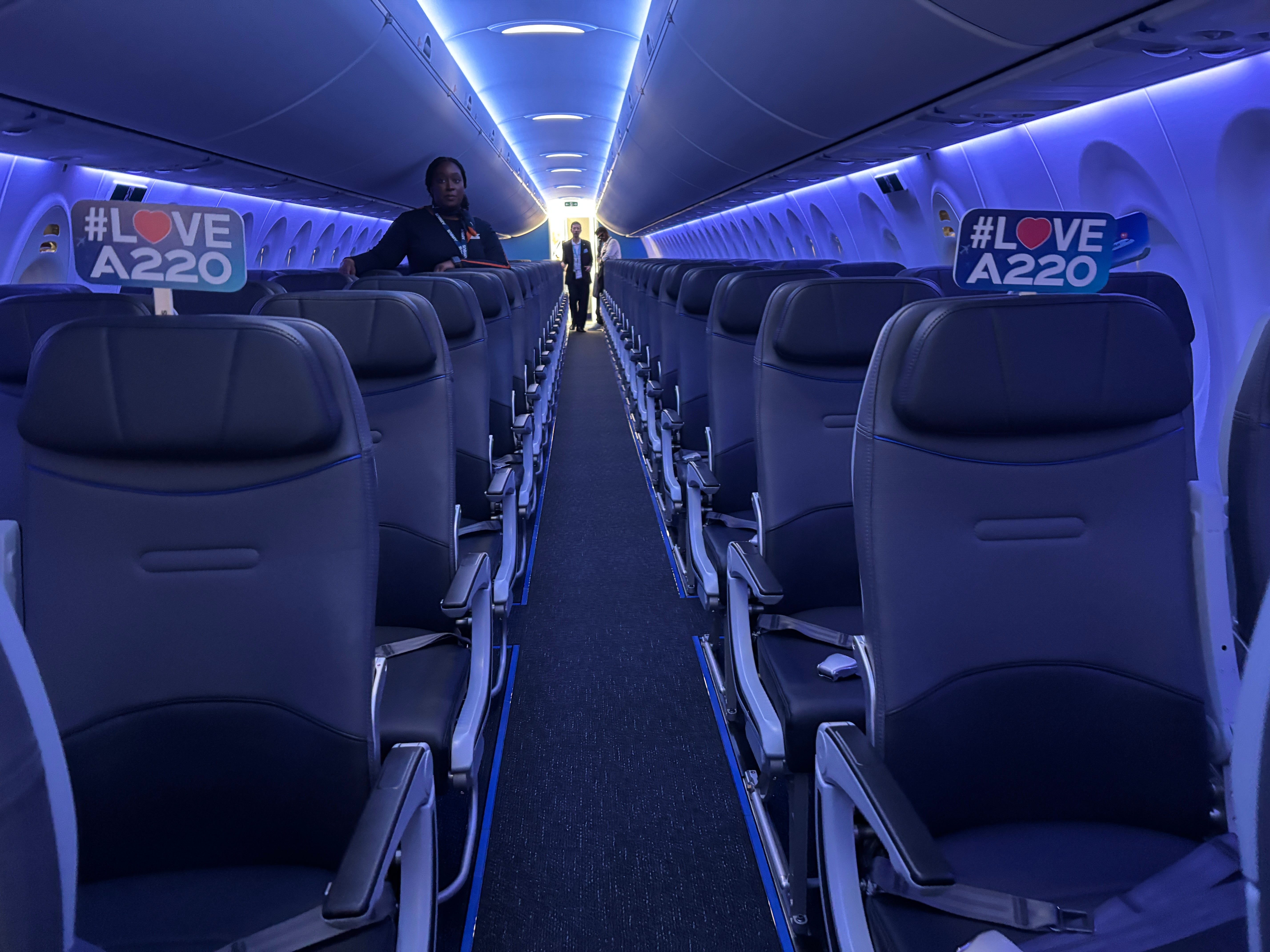 A view down the aisle of a JetBlue Airbus A220