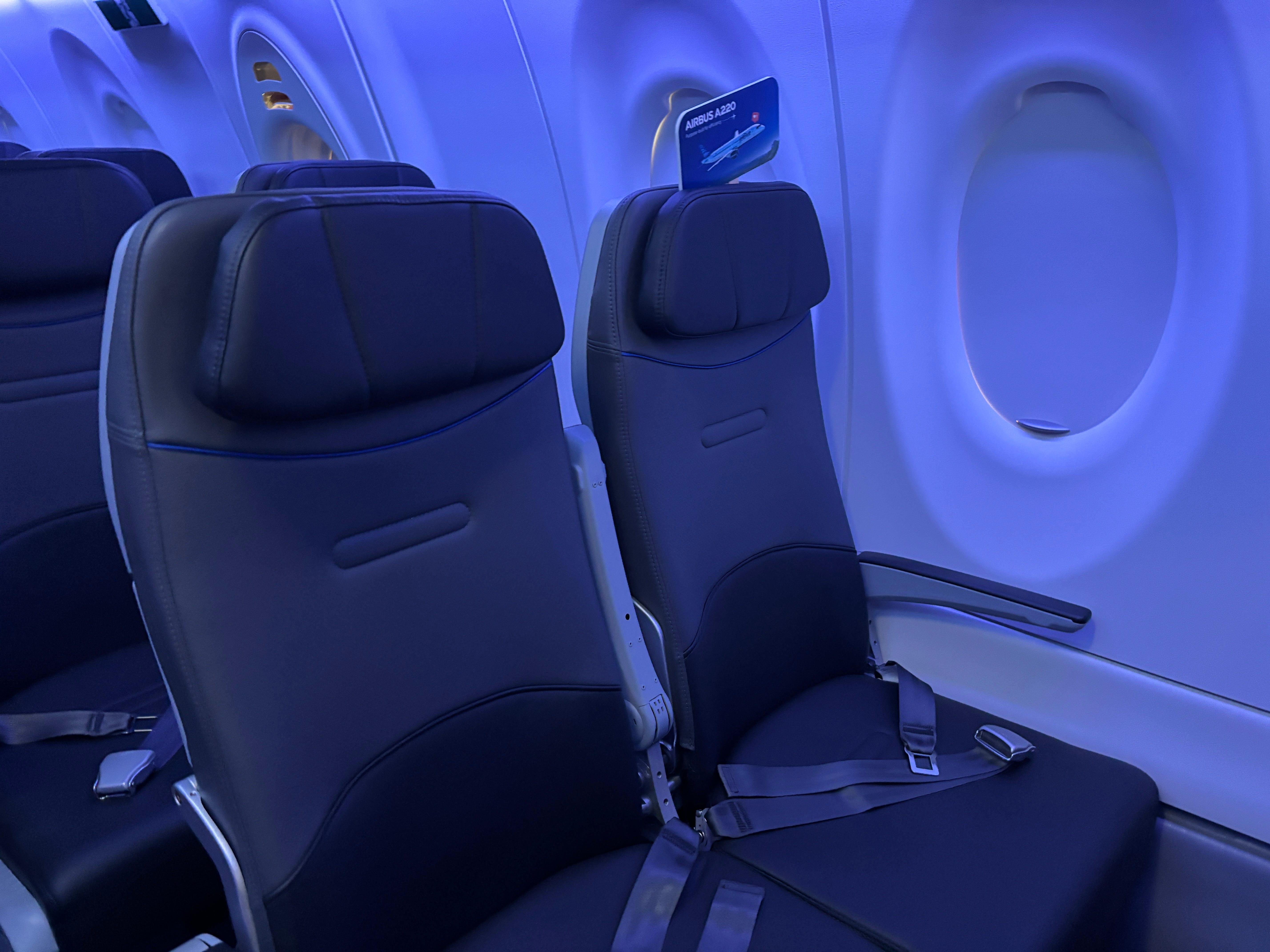 A row of two economy seats on board a JetBlue Airbus A220