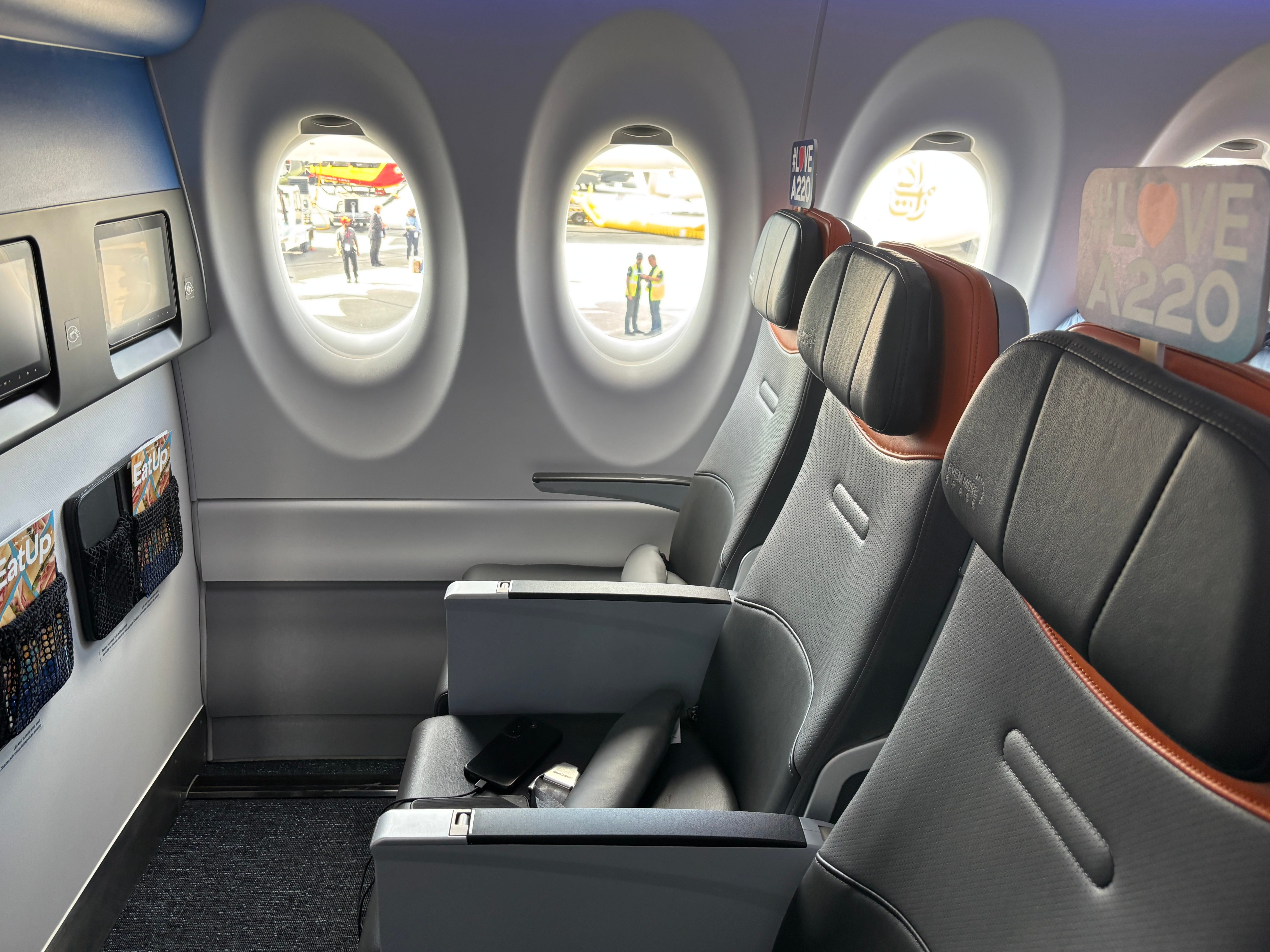 A row of premium seats at the front of a JetBlue Airbus A220