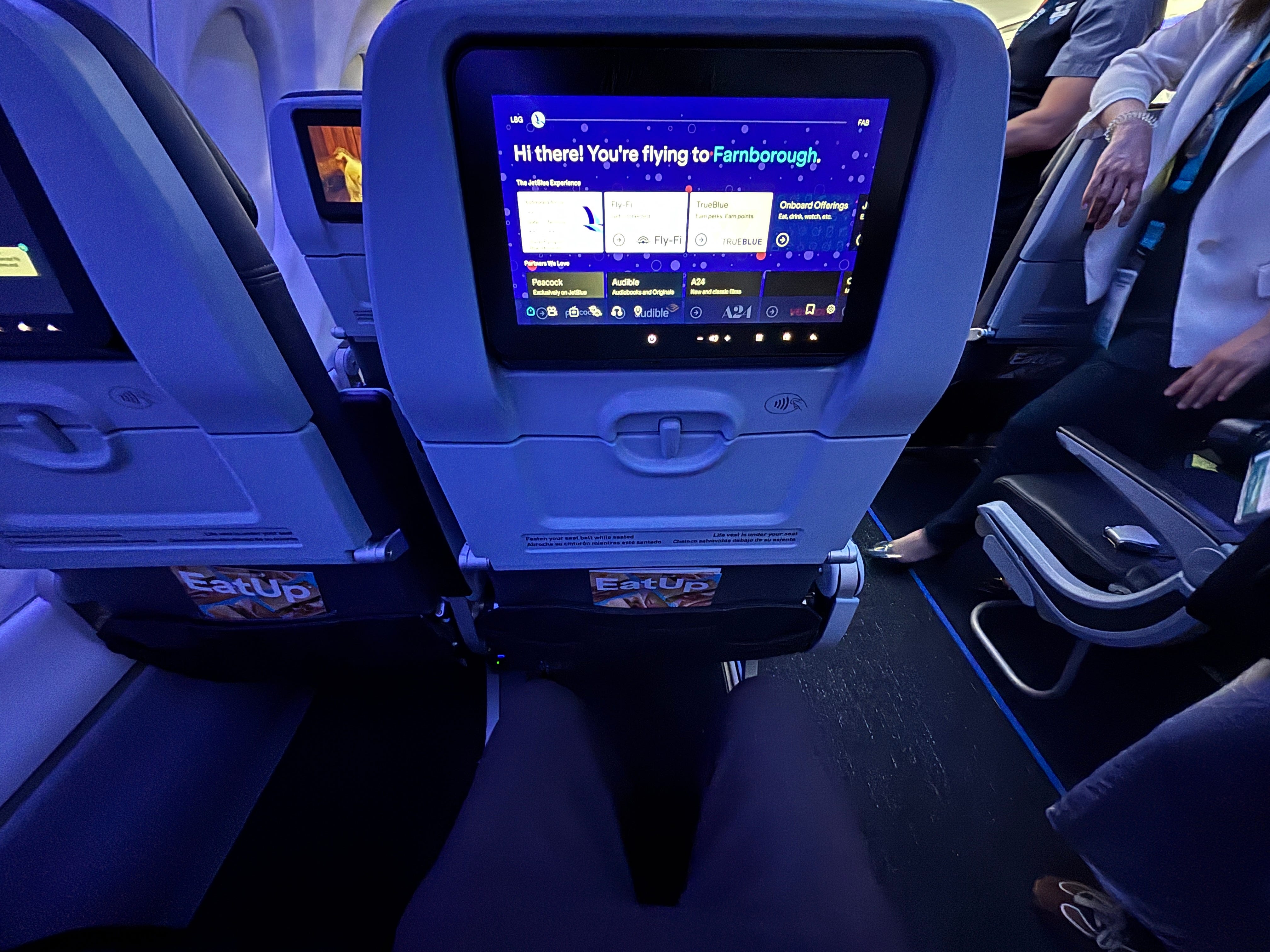 A first-person view of the legroom in economy class on a JetBlue Airbus A220