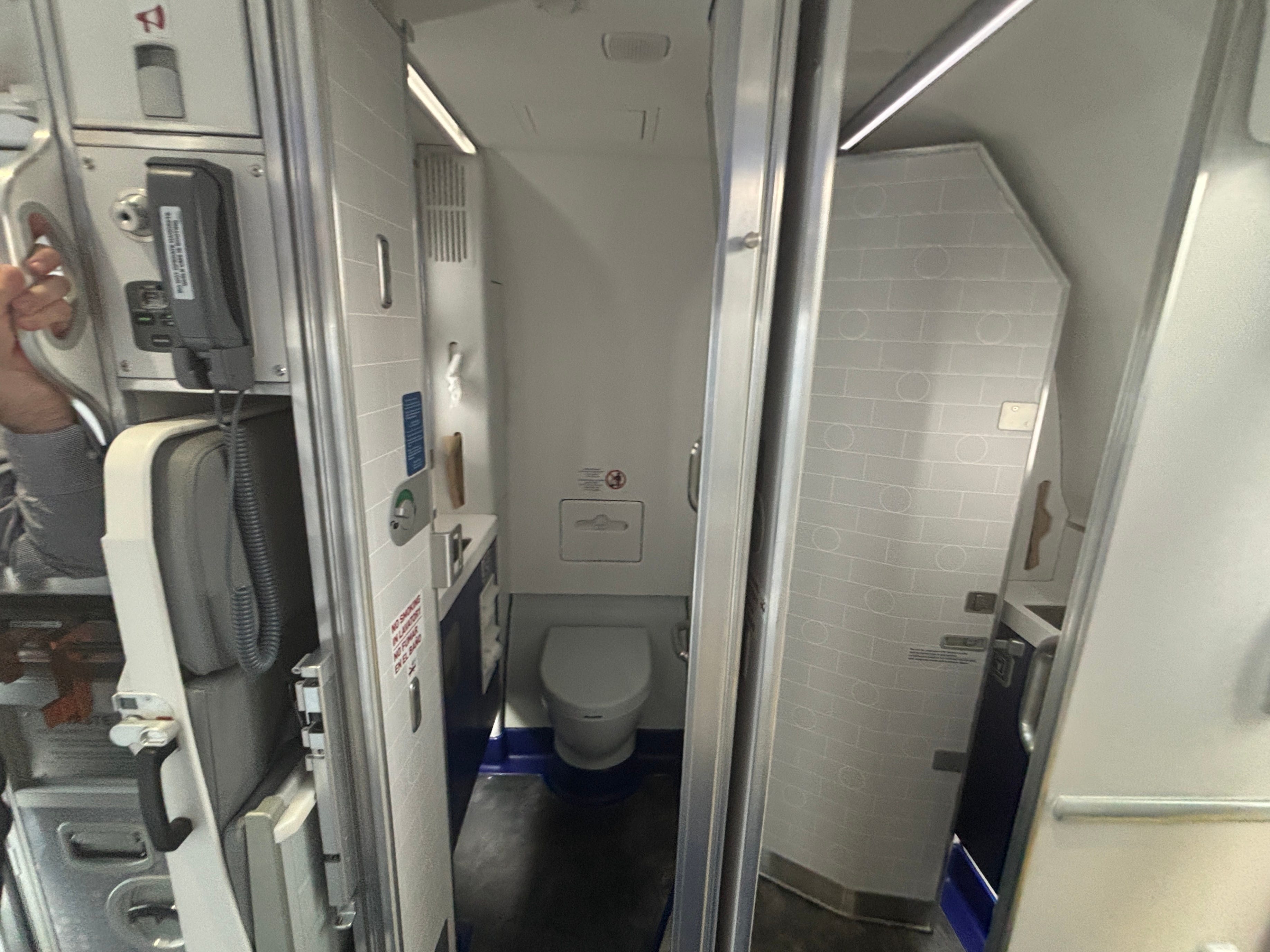 Two bathrooms at the rear of a JetBlue Airbus A220