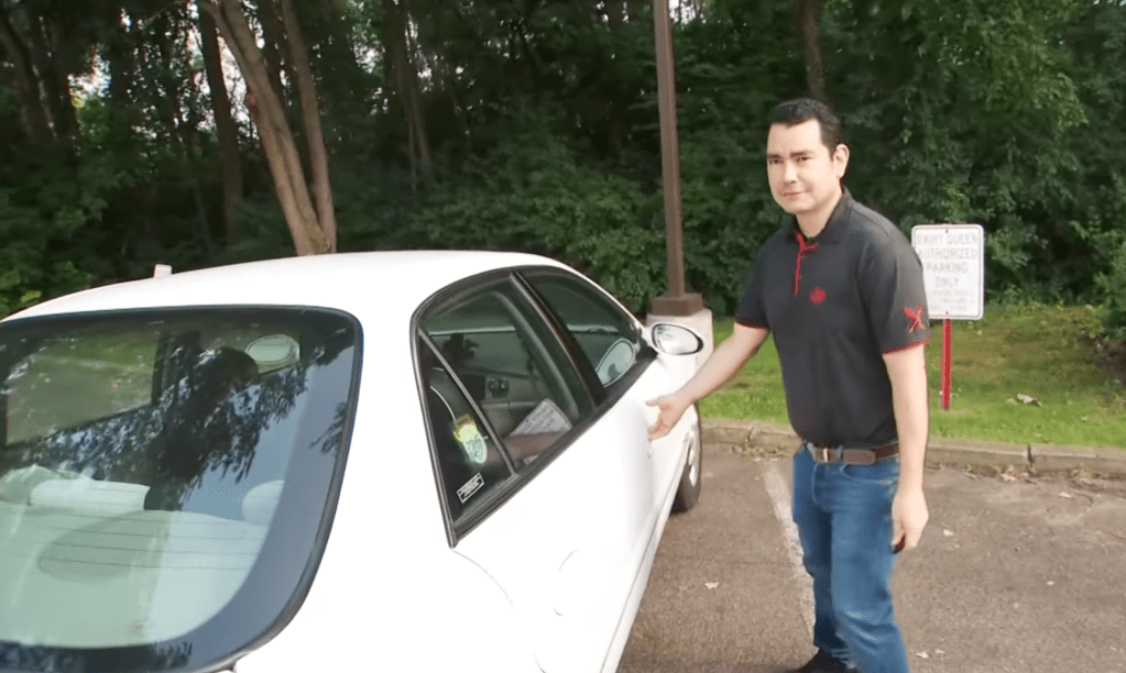 Rodolfo Depaz stands with his 2000 Buick Century, he received as a gift from a friend he met a Bible study.