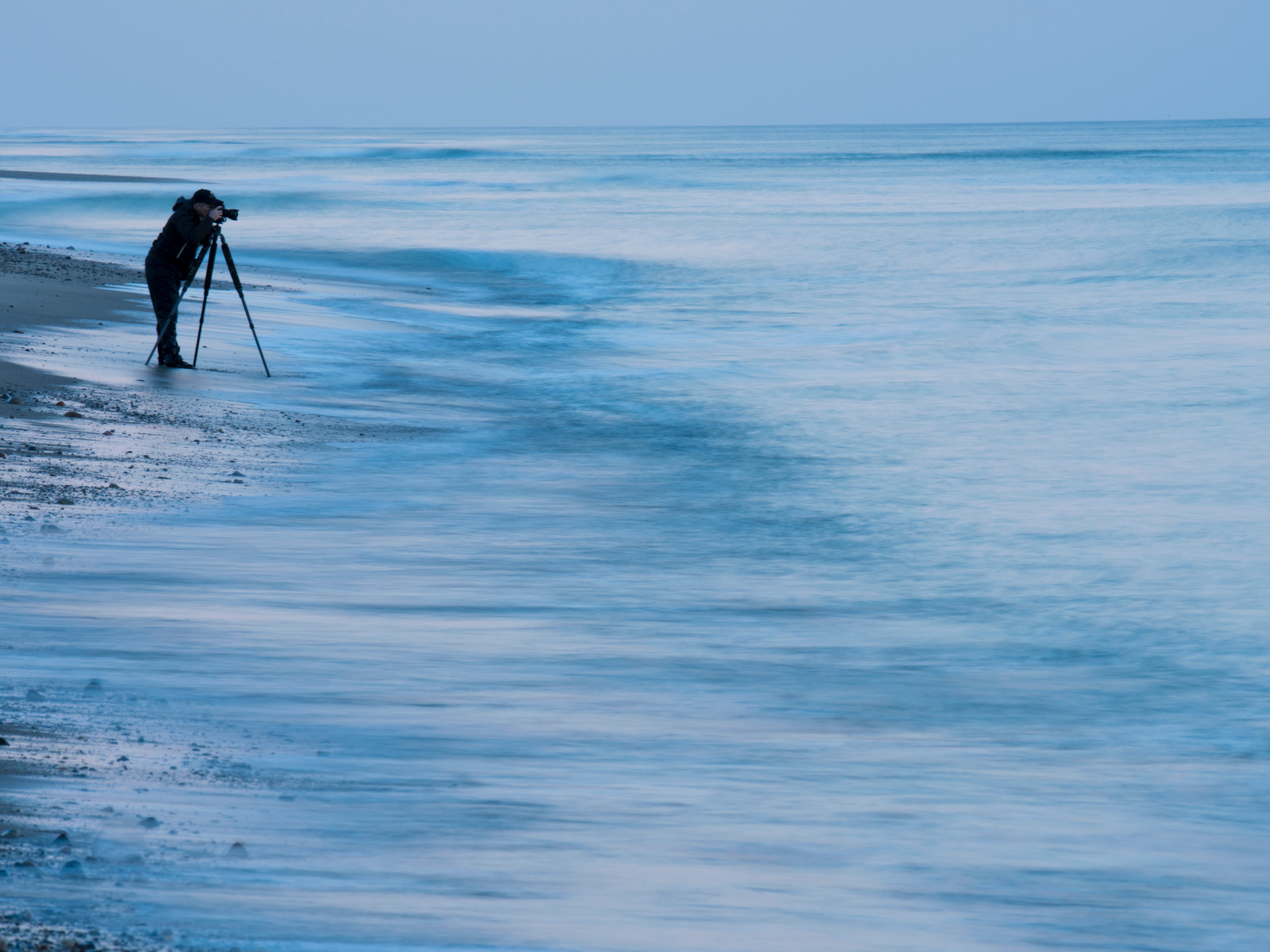 A photographer takes images at Marconi Beach in Wellfleet, Massachusetts.