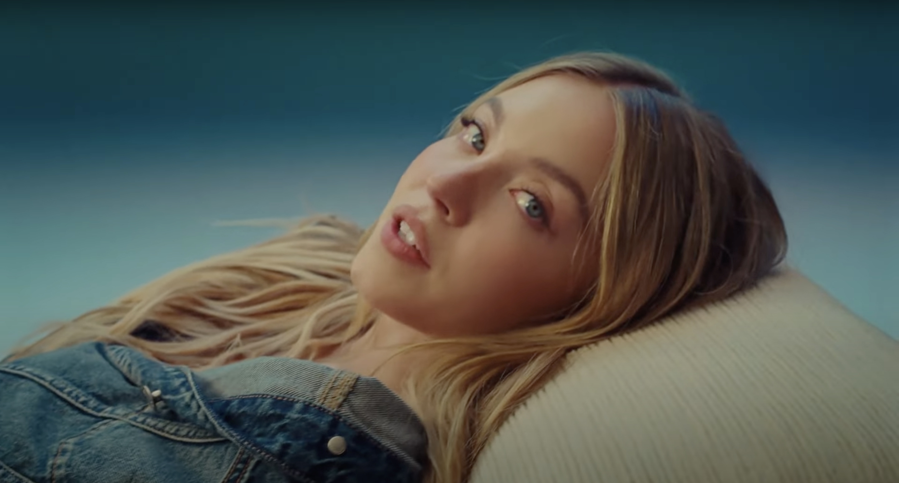 Sydney Sweeney posing in jeans for American Eagle.