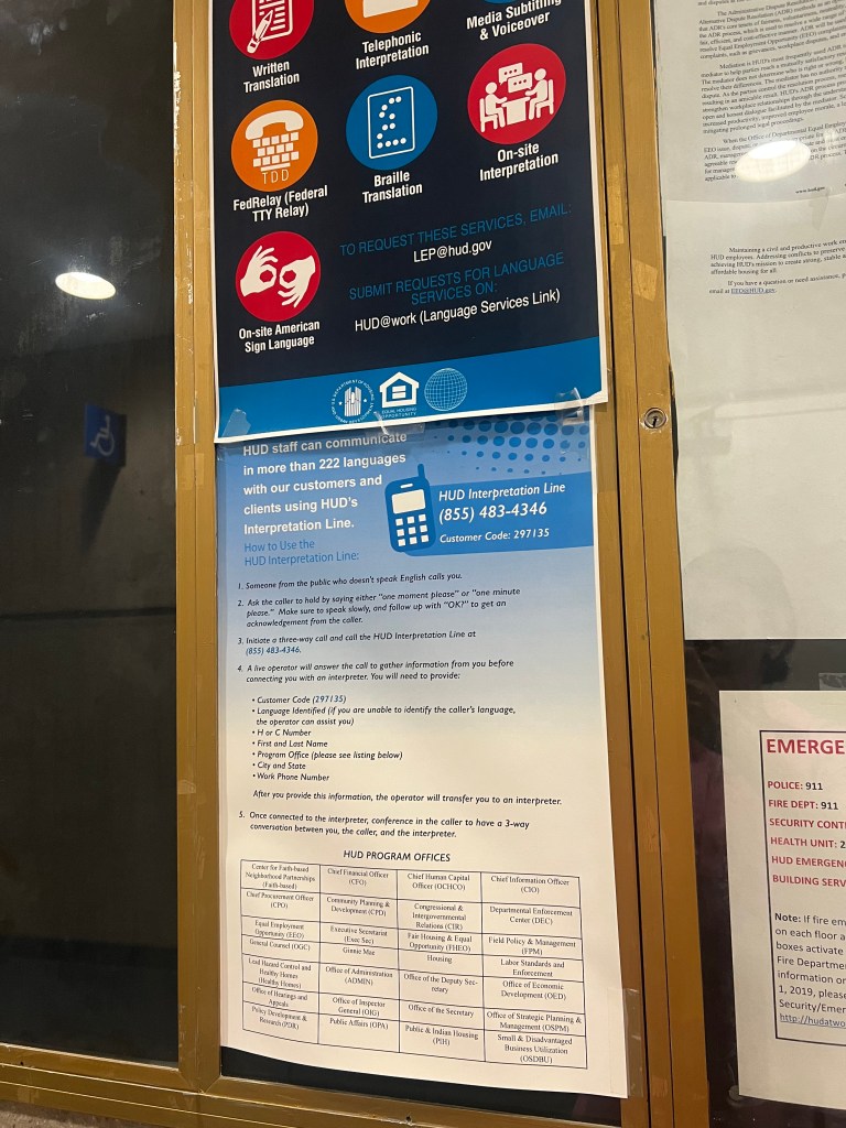 Photo of a sign listing HUD language services and contact information.