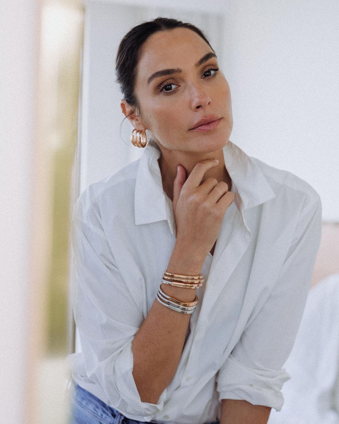 Gal Gadot posing in a white shirt
