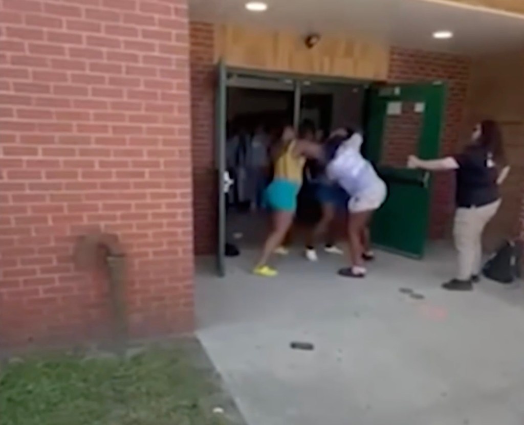 A mother assaulting a teenager with a metal water bottle outside a high school.