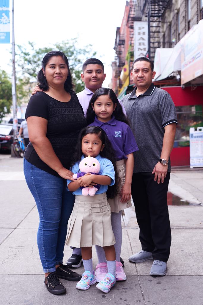 Family portrait of five people in front of a Bronx street.