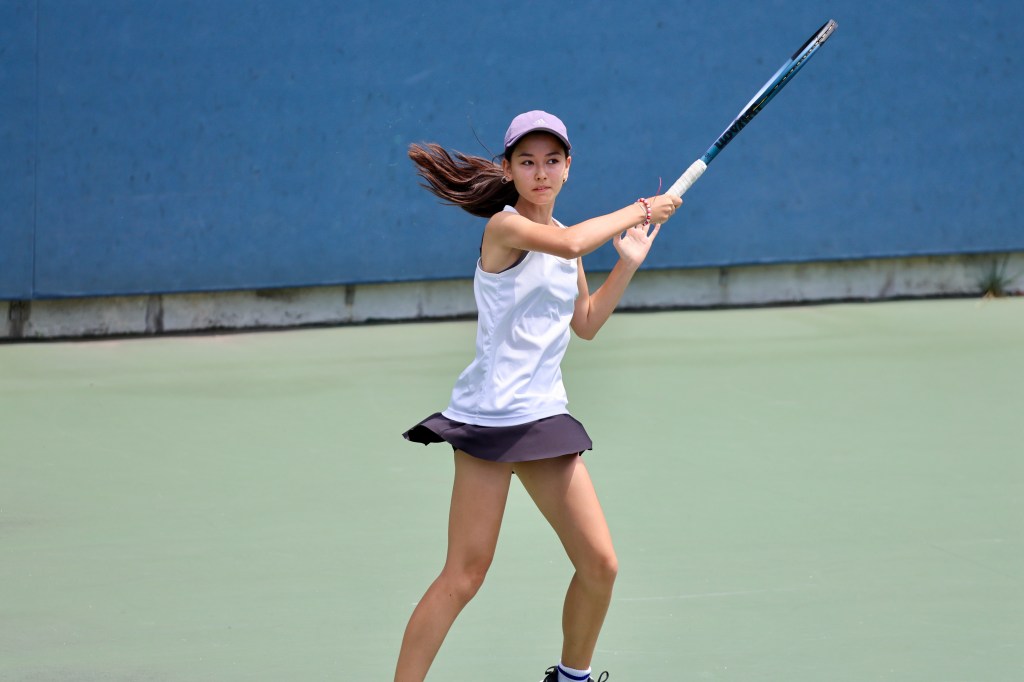 Akari Weintzen, a Ball Kid, playing tennis.