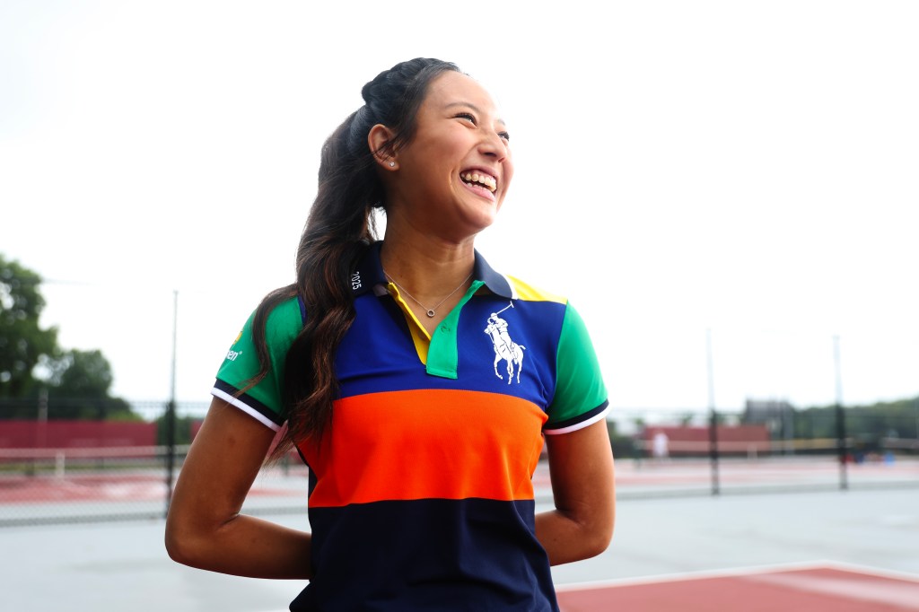 Portrait of Olivia Chen, a ball kid at the US Open, smiling at tennis courts.