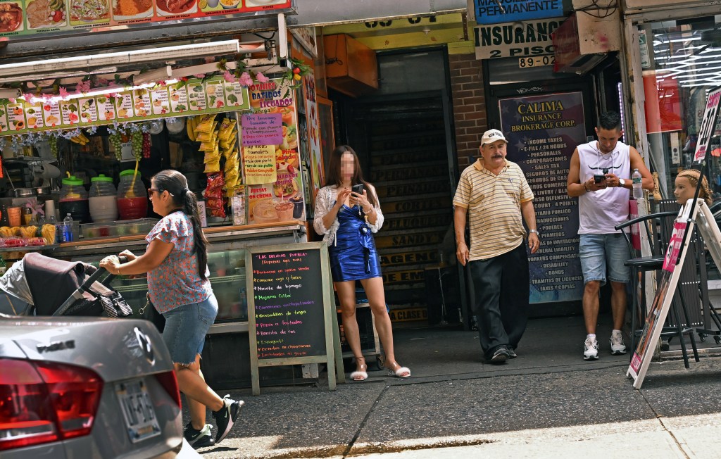 A suspected sex worker seen outside of a brothel on Roosevelt Avenue near 89th Street in Queens on Aug. 17, 2025.