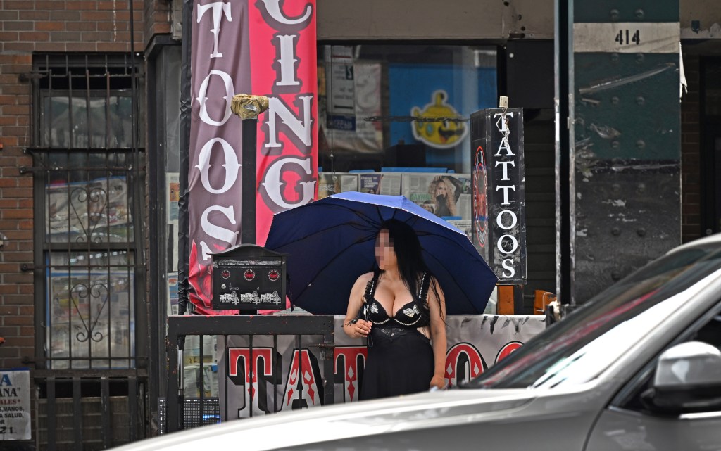 A suspected sex worker seen outside of a brothel on Roosevelt Avenue near 89th Street in Queens on Aug. 17, 2025.