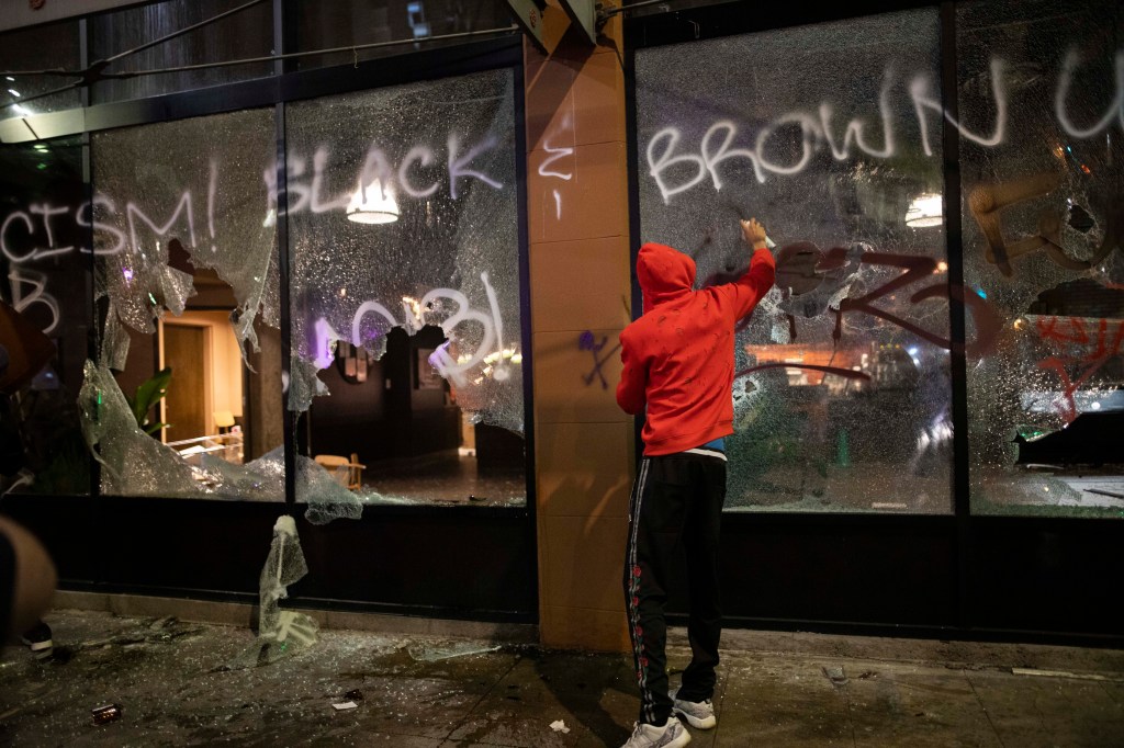 Protesters looting and vandalizing a Starbucks in downtown LA during the BLM protests on May 29, 2020.