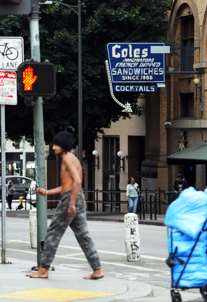 A barefoot homeless man seen walking outside of Cole's French Dip.