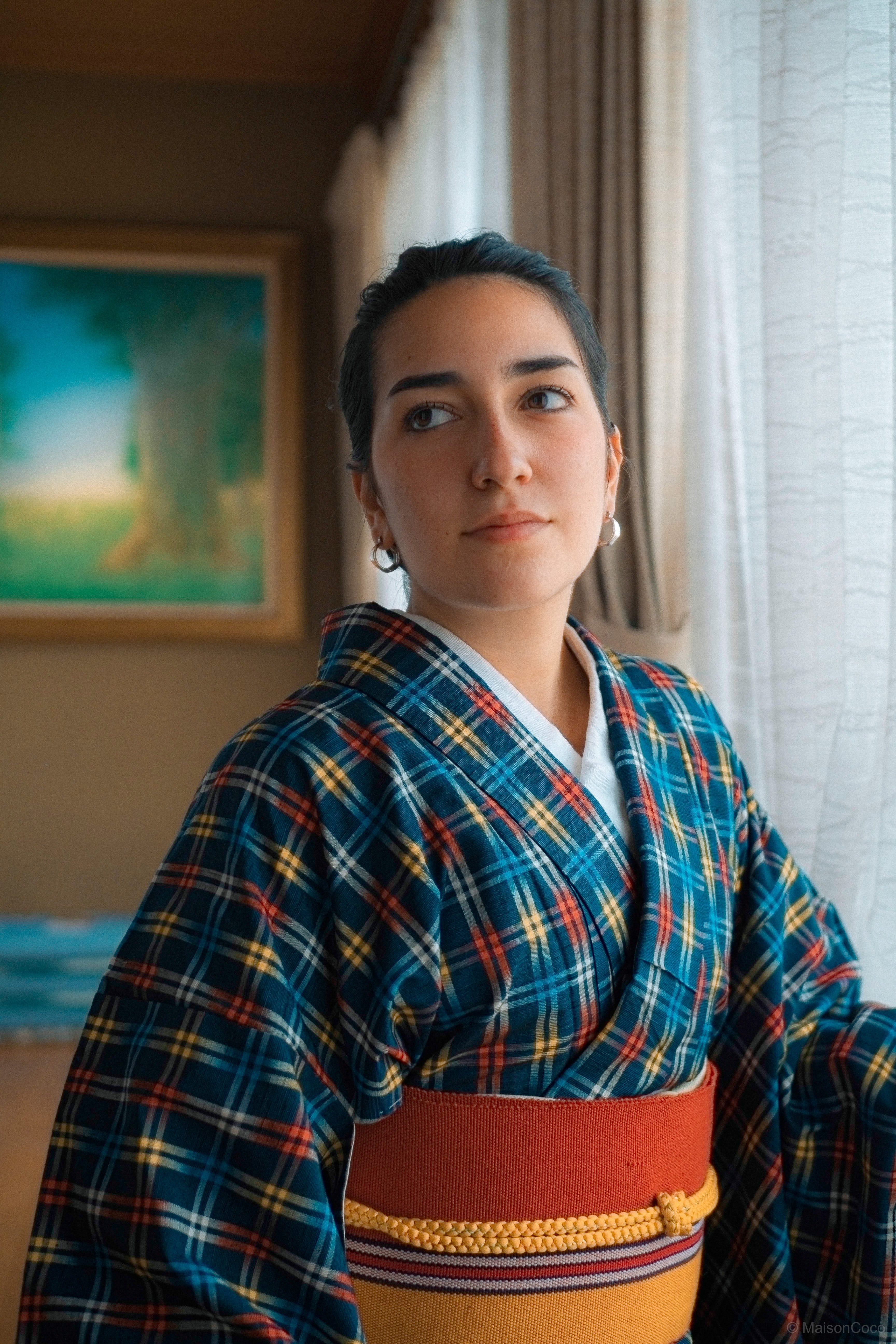 A woman posing for a photo in a Japanese kimono.