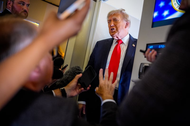 IN FLIGHT - AUGUST 15: U.S. President Donald Trump speaks to members of the media aboard Air Force One on August 15, 2025, in flight. President Trump is traveling to Anchorage, Alaska, for peace talks with Russian President Vladimir Putin on the war with Ukraine. (Photo by Andrew Harnik/Getty Images)