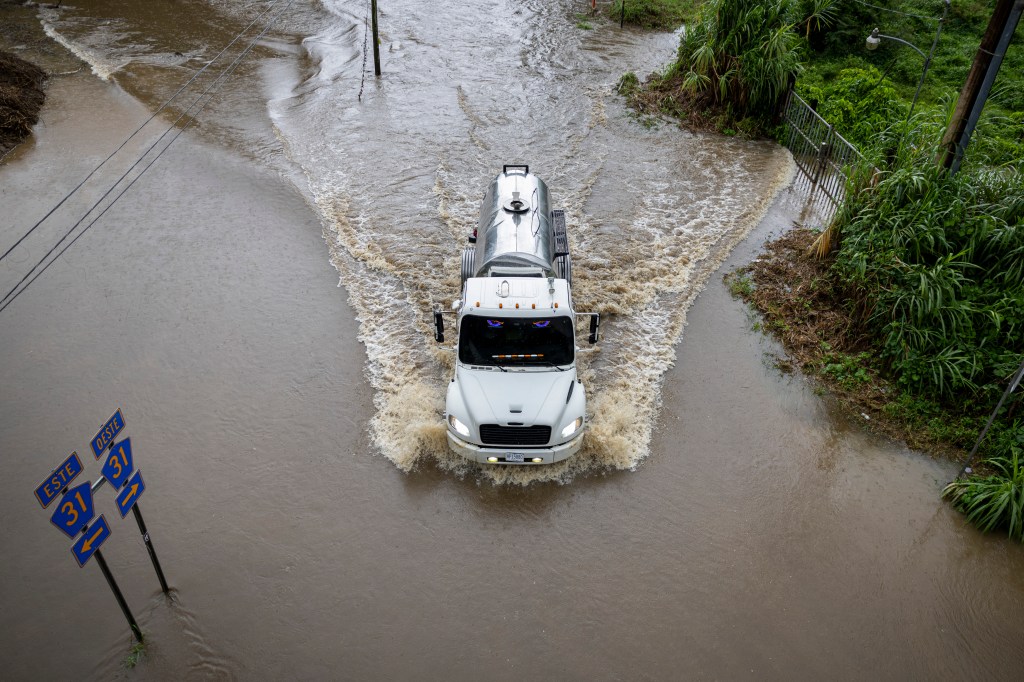 A truck driving through flooding caused by Hurricane Erin in Naguabo, Puerto Rico on Aug. 16, 2025.