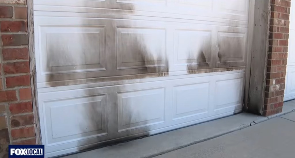 Soot-stained white garage door.