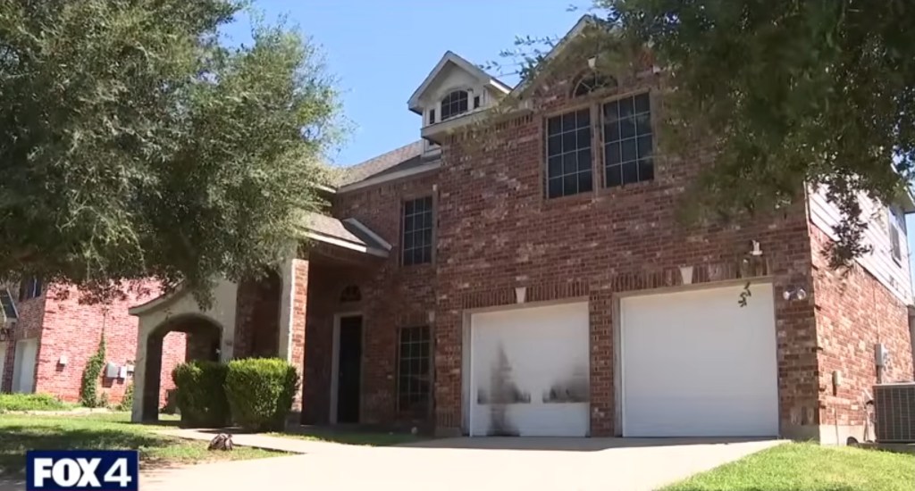 Two-story brick house with a double garage.