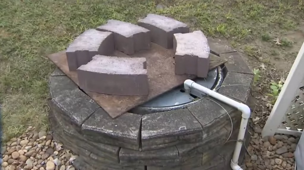 Stone pavers on a metal plate covering a water feature.