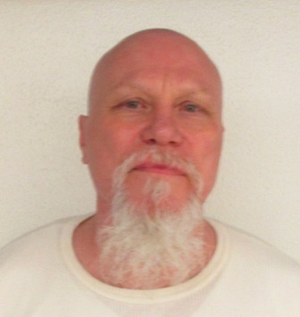 Headshot of a bald man with a long white goatee.