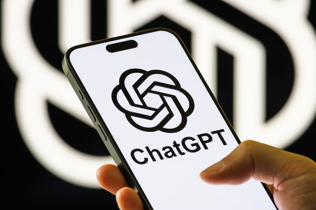 Illustration of a hand holding a smartphone displaying the ChatGPT logo.