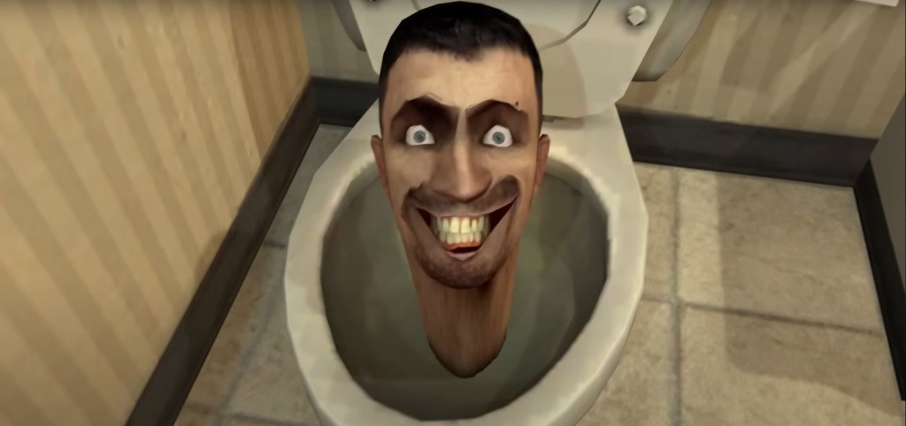 A man's head submerged in a toilet bowl.