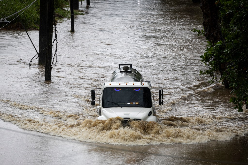 Truck driving through floodwaters.