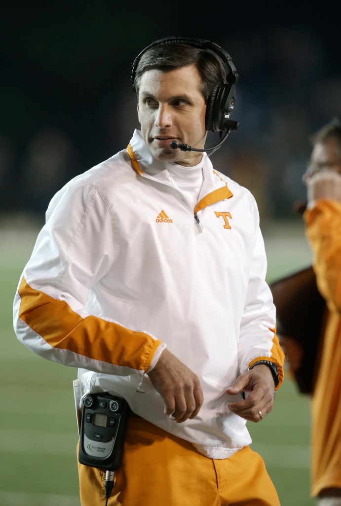Derek Dooley on the sidelines wearing a Tennessee Volunteers jacket and headset.