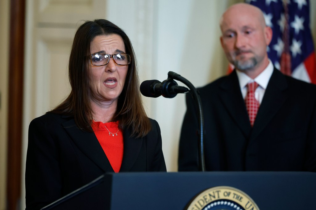 Photo of Allyson Philips speaking at a podium, with Jason Riley standing behind her.