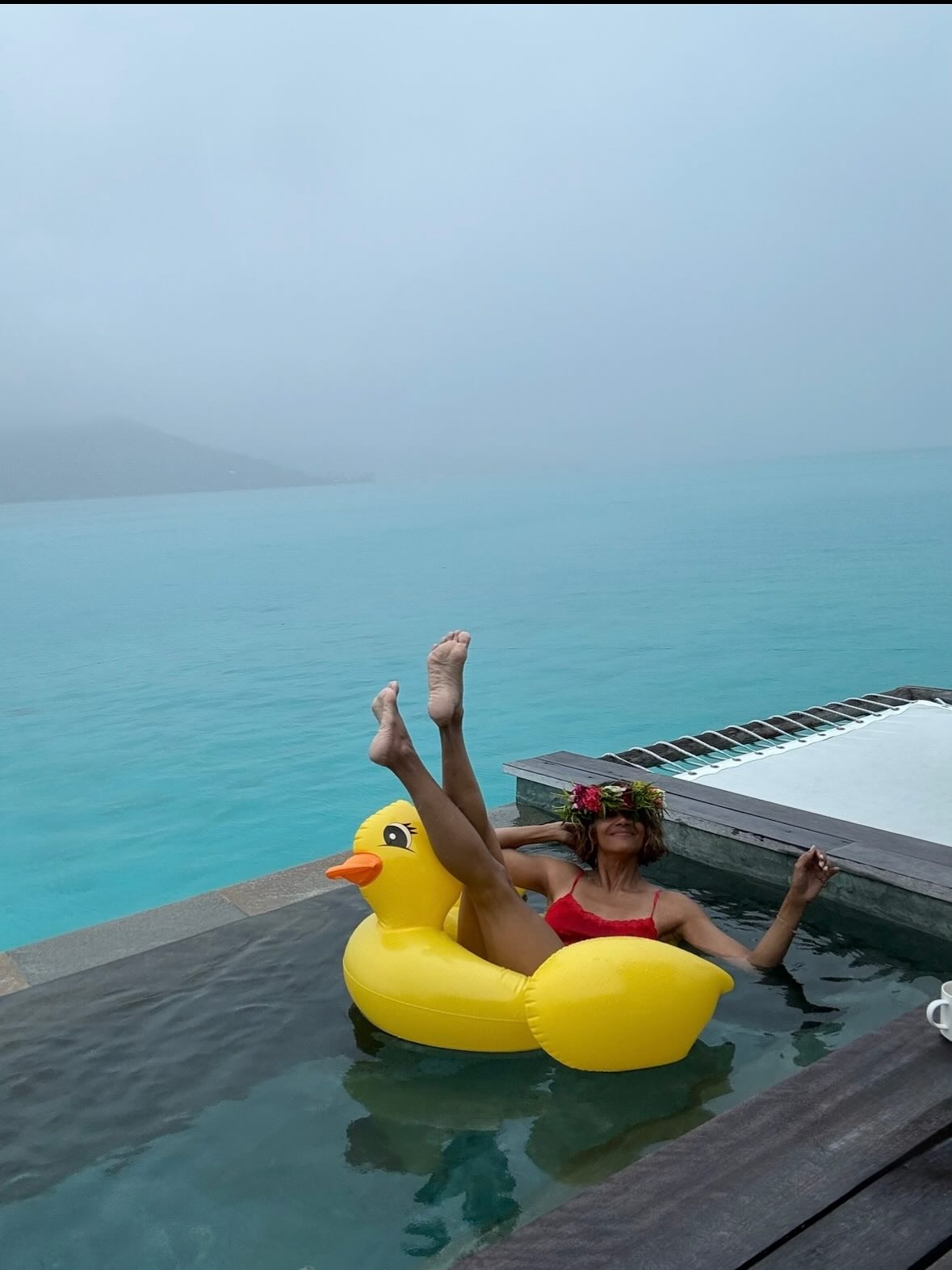 Halle Berry doesn't let a cloudy day bring her down as she lounges on a duck float in the pool.