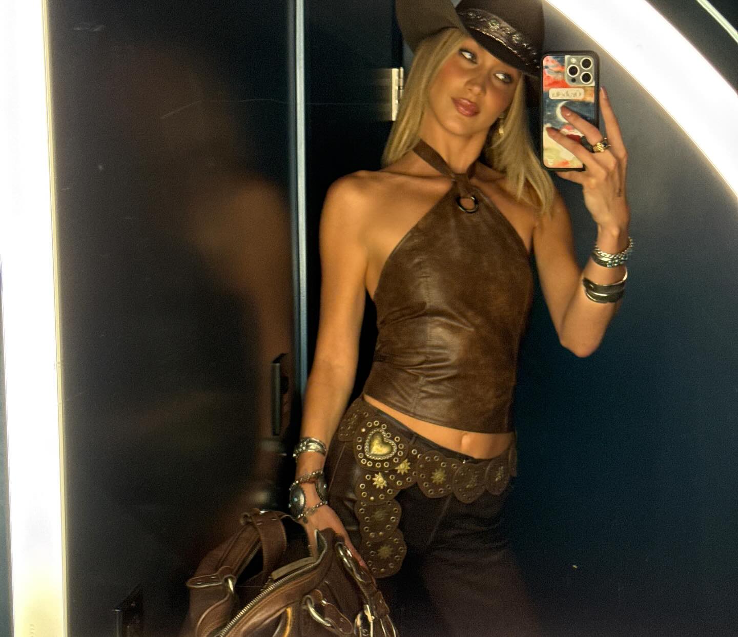 Bella Hadid channels her inner cowgirl in a mirror snap.
