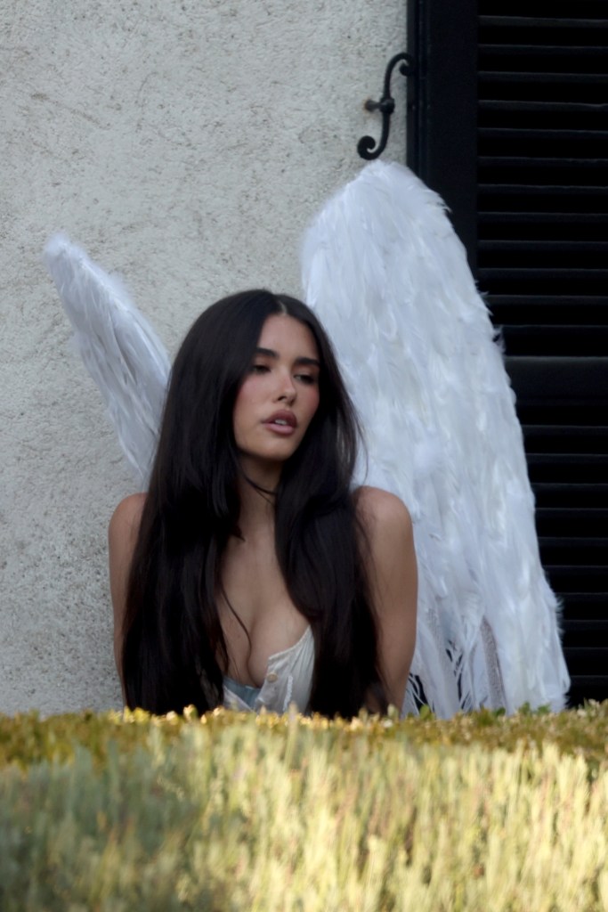 Madison Beer rocks angel wings as she poses for a photo shoot in Los Angeles.