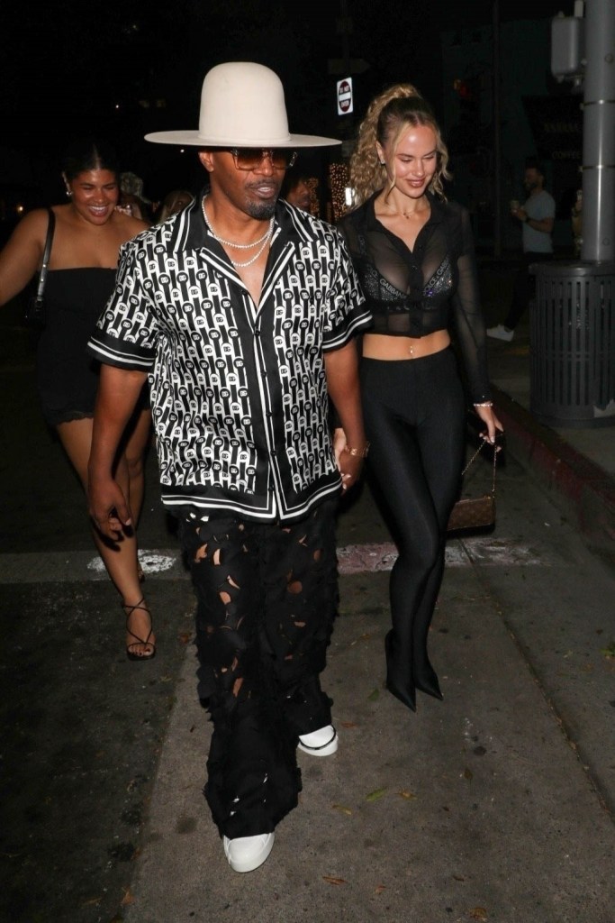 Jamie Foxx and girlfriend Alyce Huckstepp walk hand in hand during a late night dinner outing with friends and family in Los Angeles.