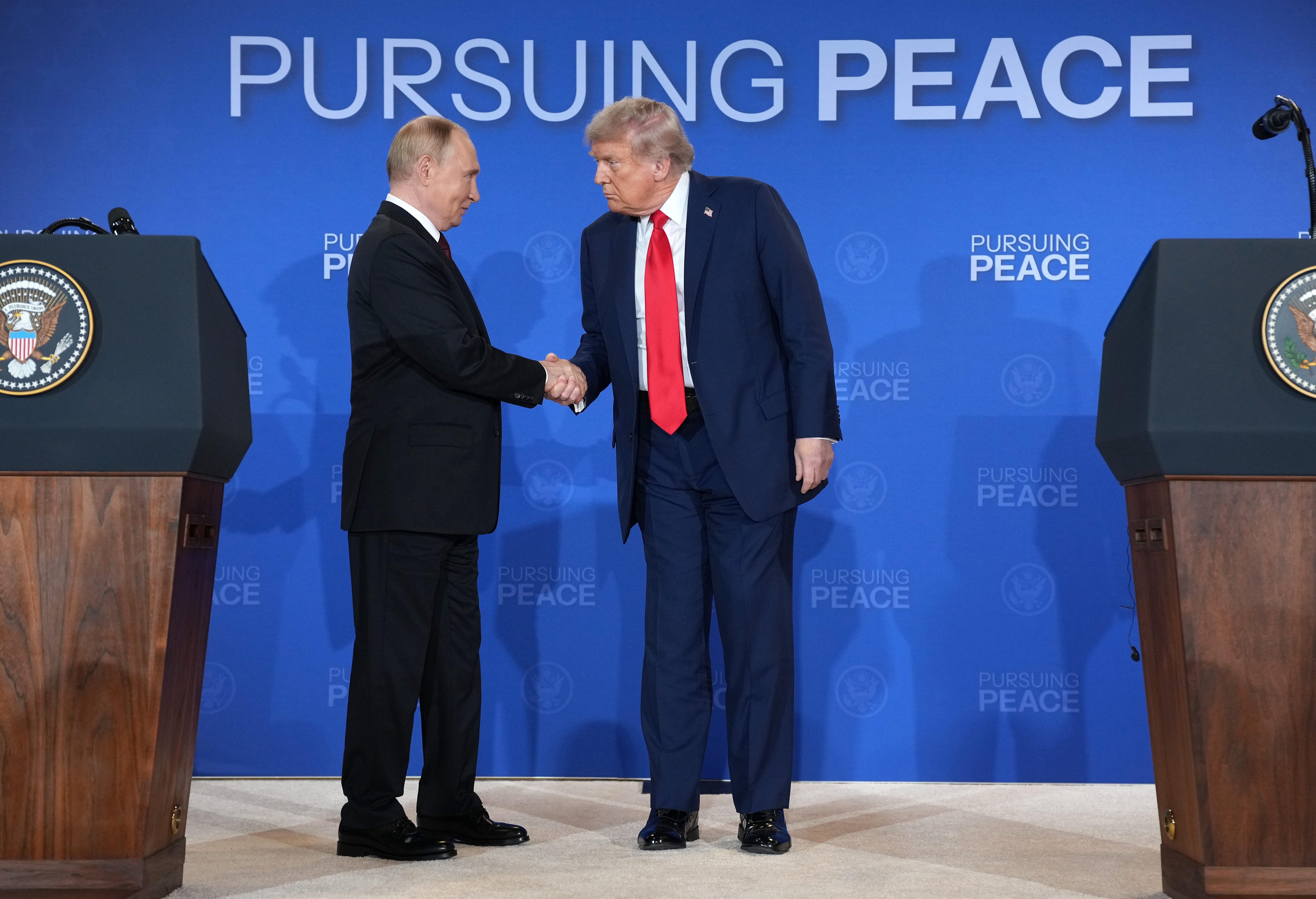 US President Donald Trump (R) and Russian President Vladimir Putin shake hands at the end of a press conference at Joint Base Elmendorf-Richardson on August 15, 2025, in Anchorage, Alaska.