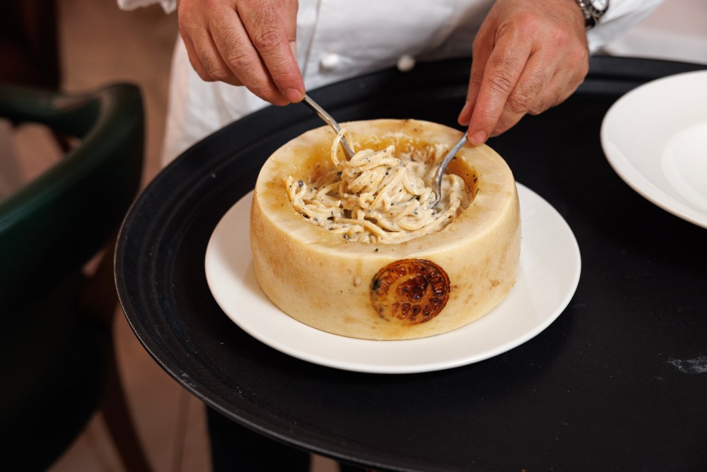 Lo Castro prepares a creamy Cacio e pepe pasta in a wheel of cheese. 