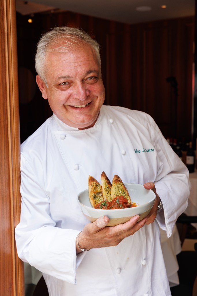 Chef Salvo Lo Castro holding a bowl of meatballs.