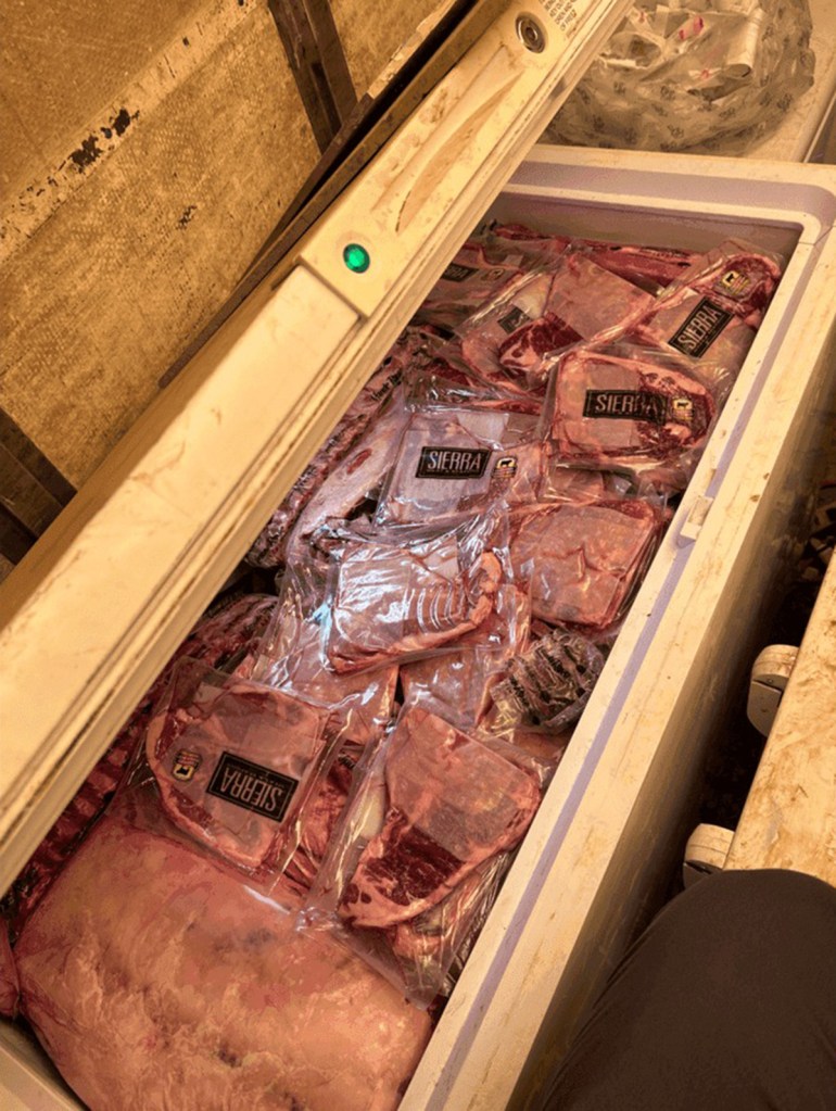 Frozen packages of meat in a freezer.
