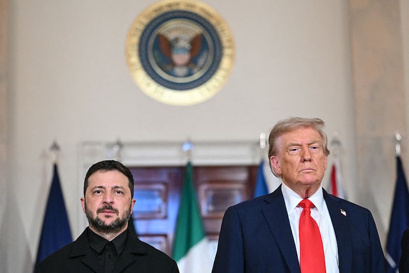 US President Donald Trump and Ukrainian President Volodymyr Zelensky stand for a family photo with European leaders in the Cross Hall of the White House in Washington, DC, on August 18, 2025. European leaders join Ukrainian President Volodymyr Zelensky in talks with US President Donald Trump on August 18, as they try to find a way to end Russia's offensive.  The leaders heading to Washington on Monday to appear alongside Zelensky call themselves the 