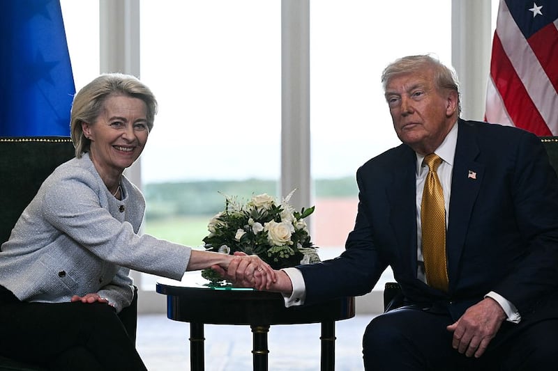 TOPSHOT - US President Donald Trump (R) shakes hands with European Commission President Ursula von der Leyen (L) after agreeing on a trade deal between the two economies following their meeting, in Turnberry south west Scotland on July 27, 2025, on the third day of his visit to the country, since his second tenure as President began. US President Donald Trump said on July 27, 2025 that he had reached a trade agreement with European Union chief Ursula von der Leyen. 